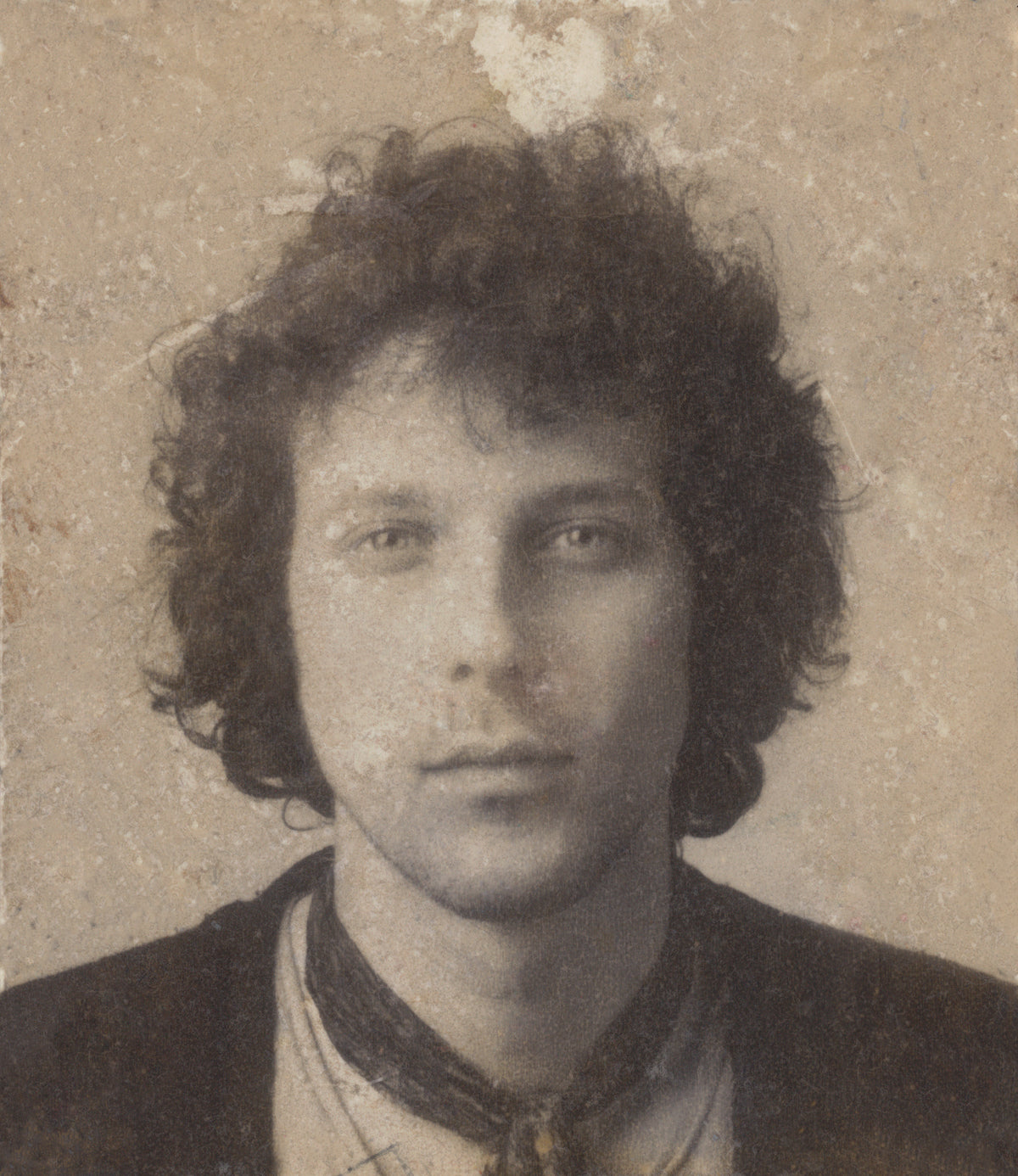 Vintage sepia portrait of Trevor Key with curly hair, collared shirt and scarf.